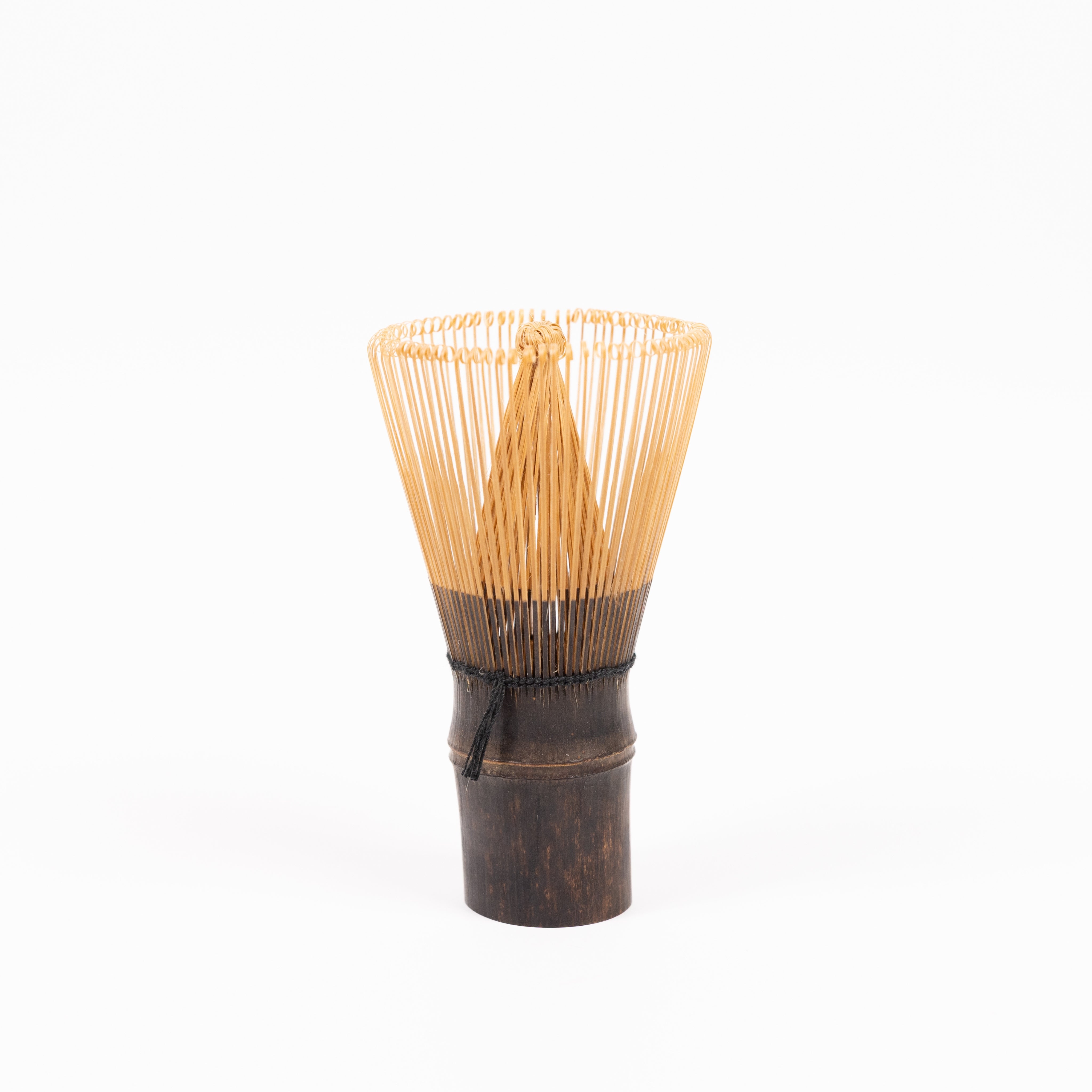120 prong purple bamboo whisk for making matcha tea on a white background