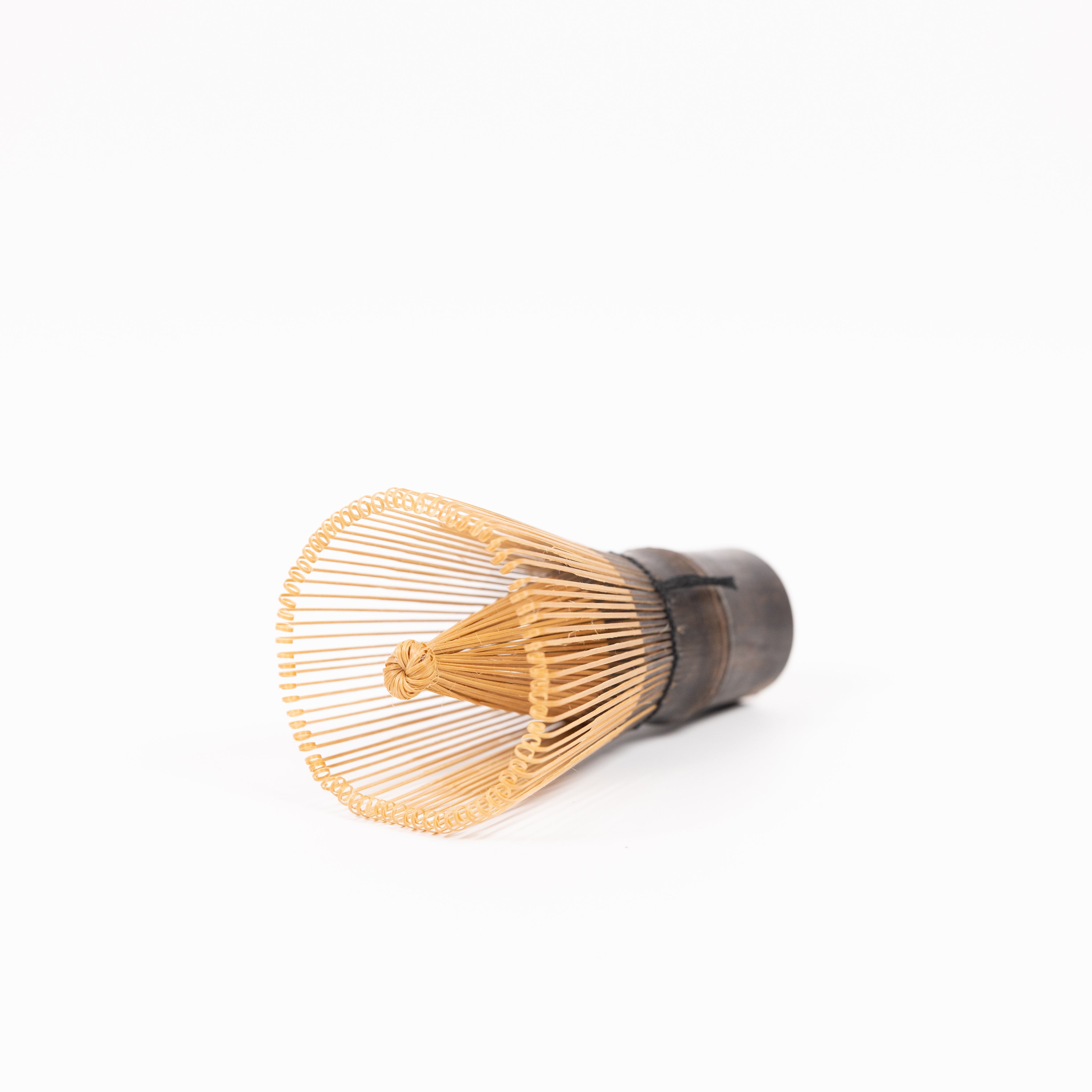 Wooden 120 prong tea whisk on a white background